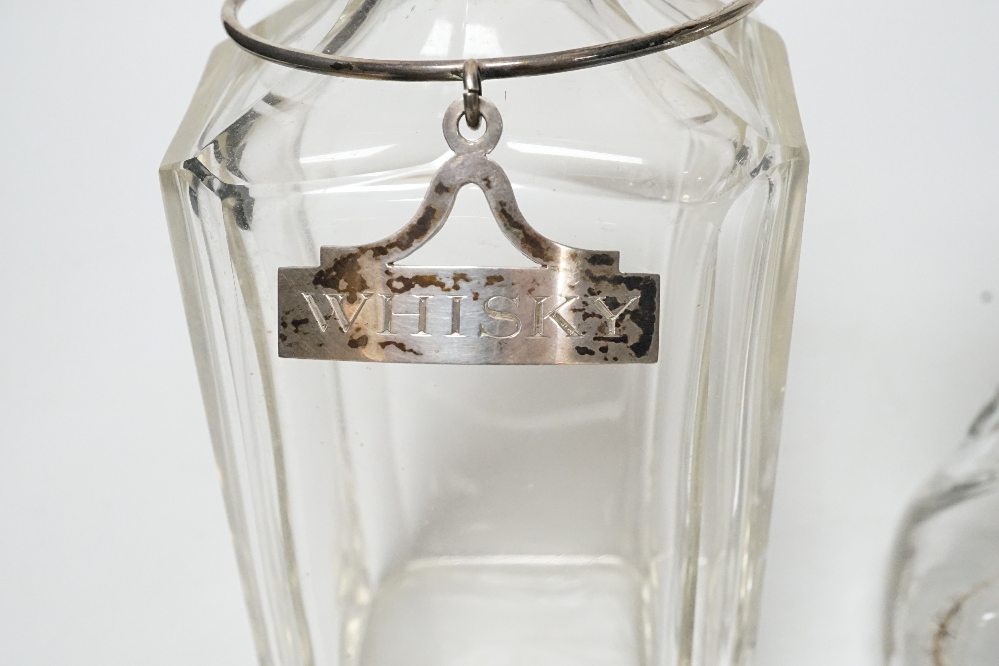 A silver mounted glass decanter with silver ‘BRANDY’ label and another